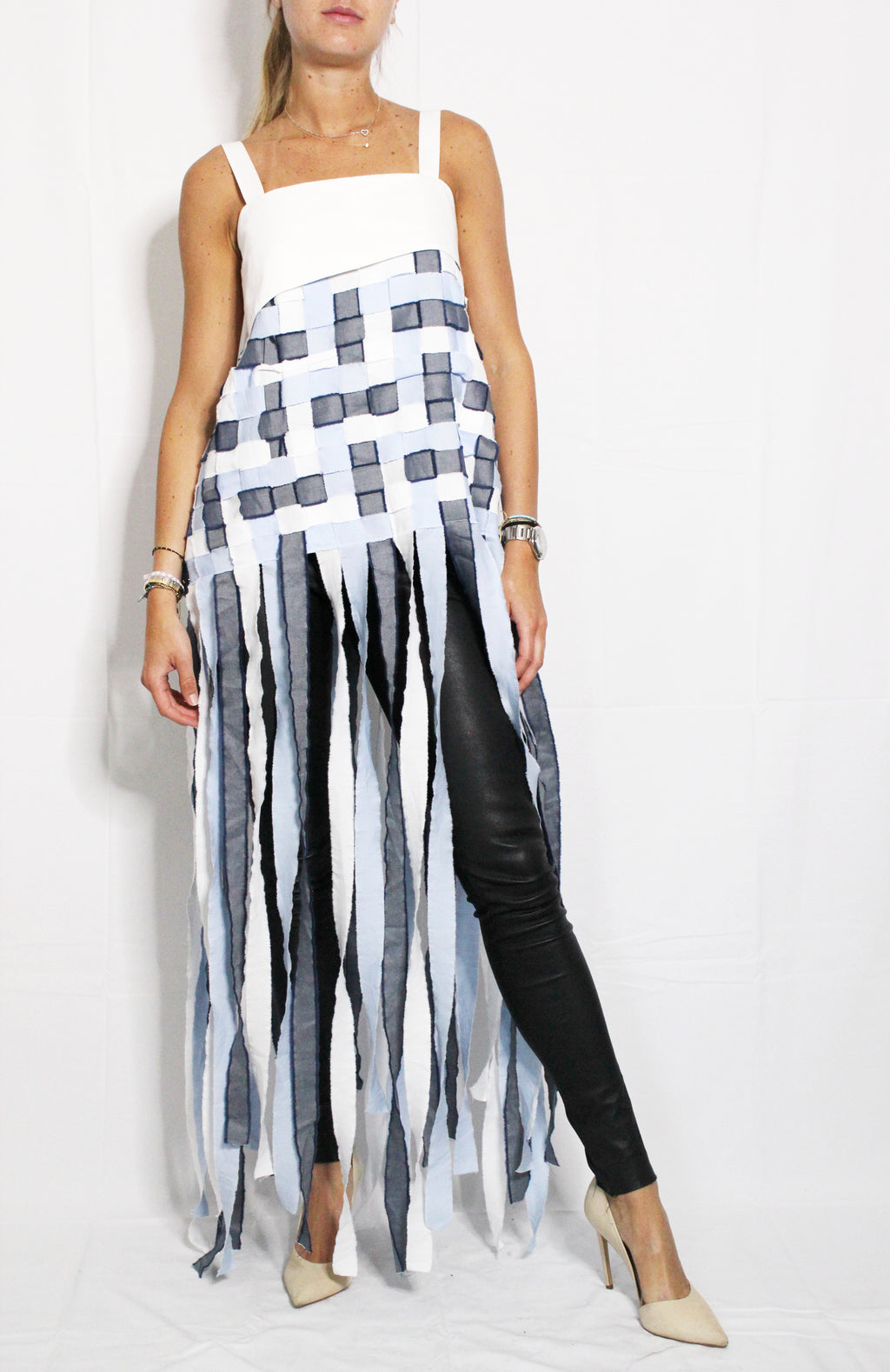 Woman wearing a white dress with black geometric patterns and black leggings on a white background. Indonesian stringy top — handmade designer cotton top with string detail from Major Minor Jakarta, relaxed fit, limited edition
