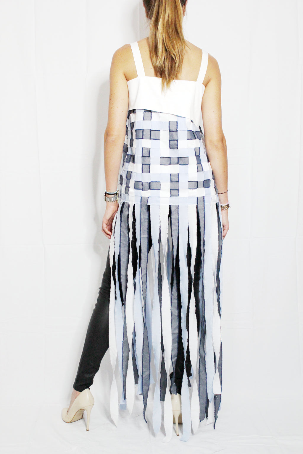 Woman wearing a white top and black and white striped skirt on a white background. Indonesian stringy top — handmade designer cotton top with string detail from Major Minor Jakarta, relaxed fit, limited edition