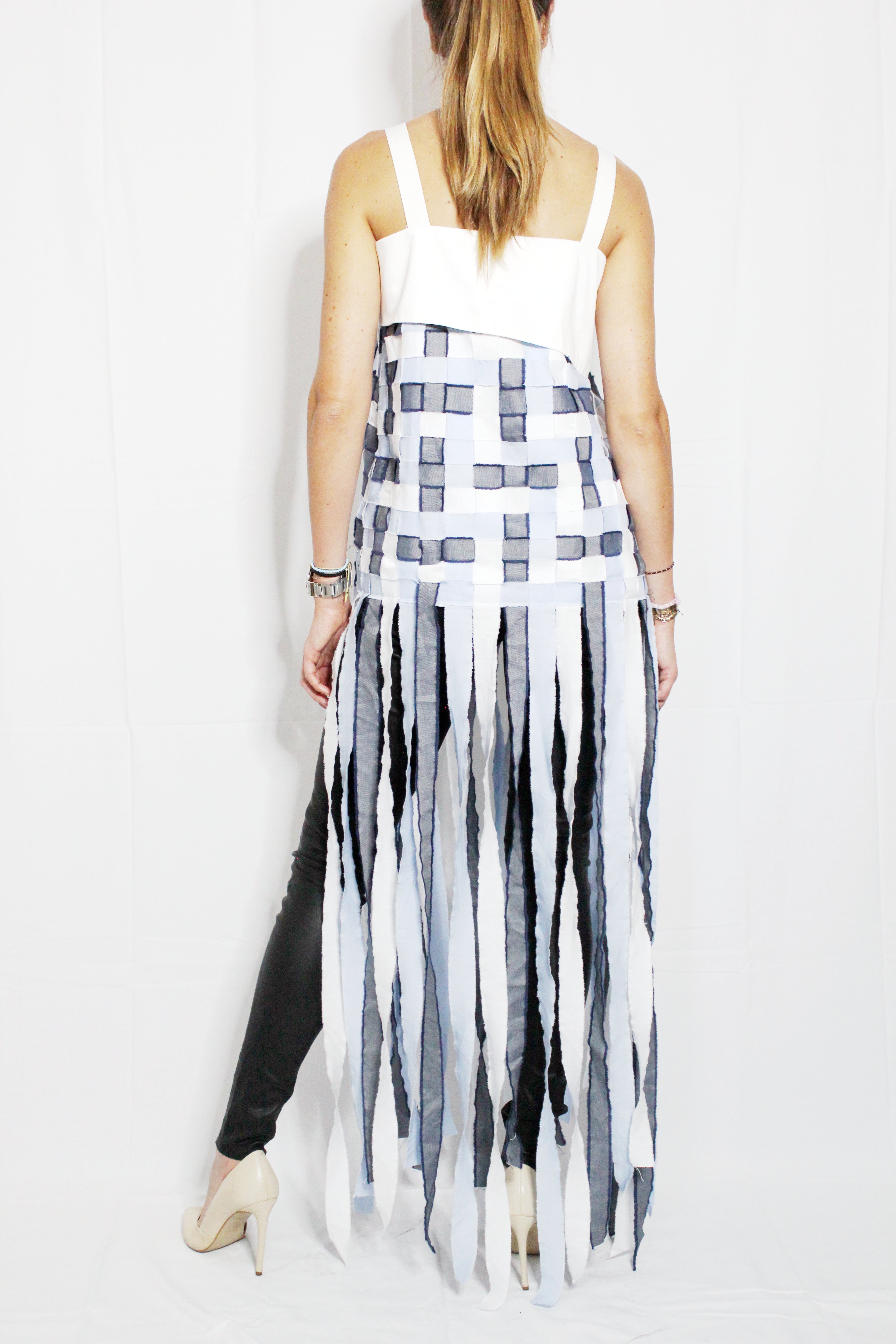 Woman wearing a white top and black and white striped skirt on a white background. Indonesian stringy top — handmade designer cotton top with string detail from Major Minor Jakarta, relaxed fit, limited edition