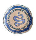 Ceramic plate with blue snake design on a beige background