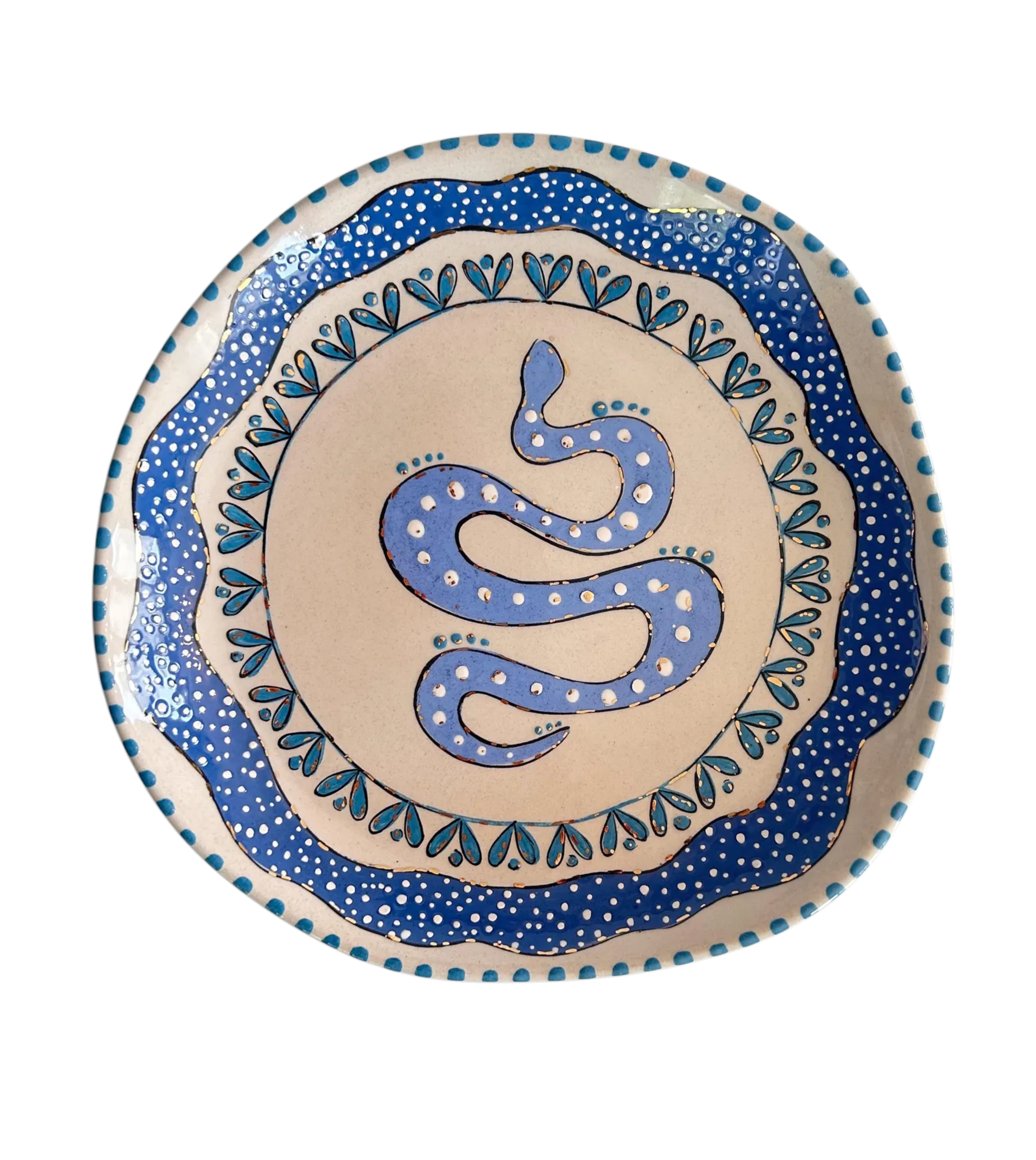 Ceramic plate with blue snake design on a beige background