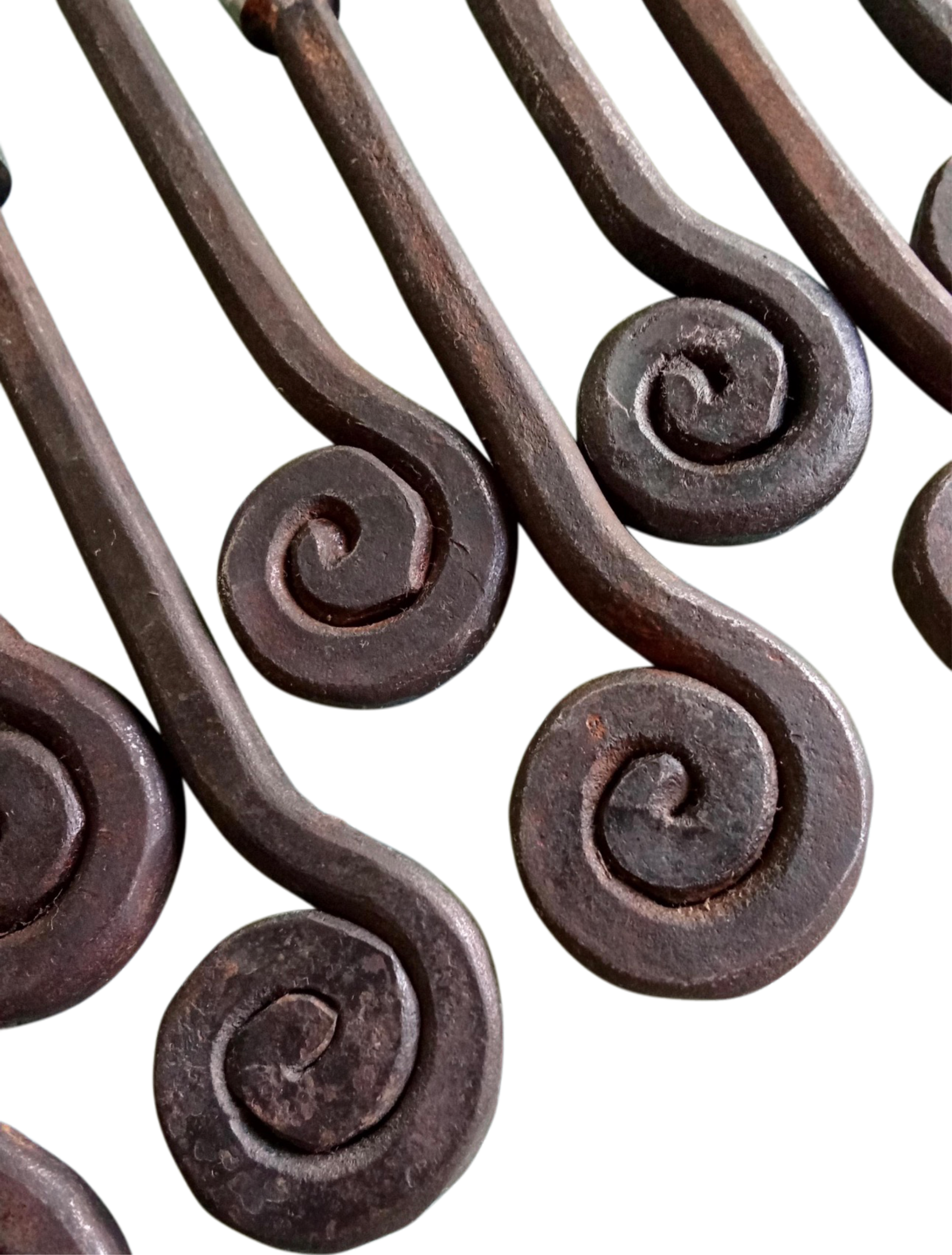 Decorative metal handles with intricate scroll design on a white background
