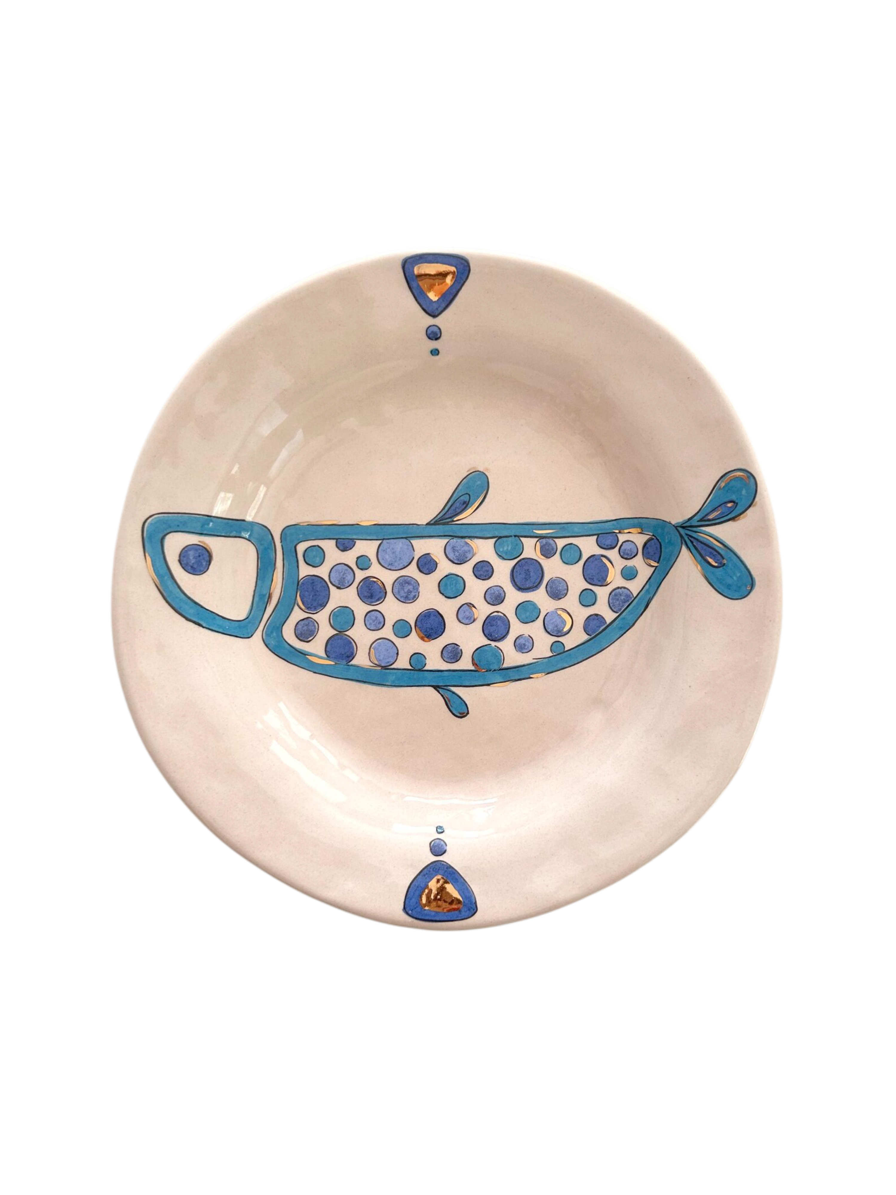 Ceramic plate with blue fish design on a beige background