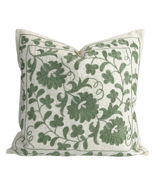 Decorative pillow with green floral pattern on a white background