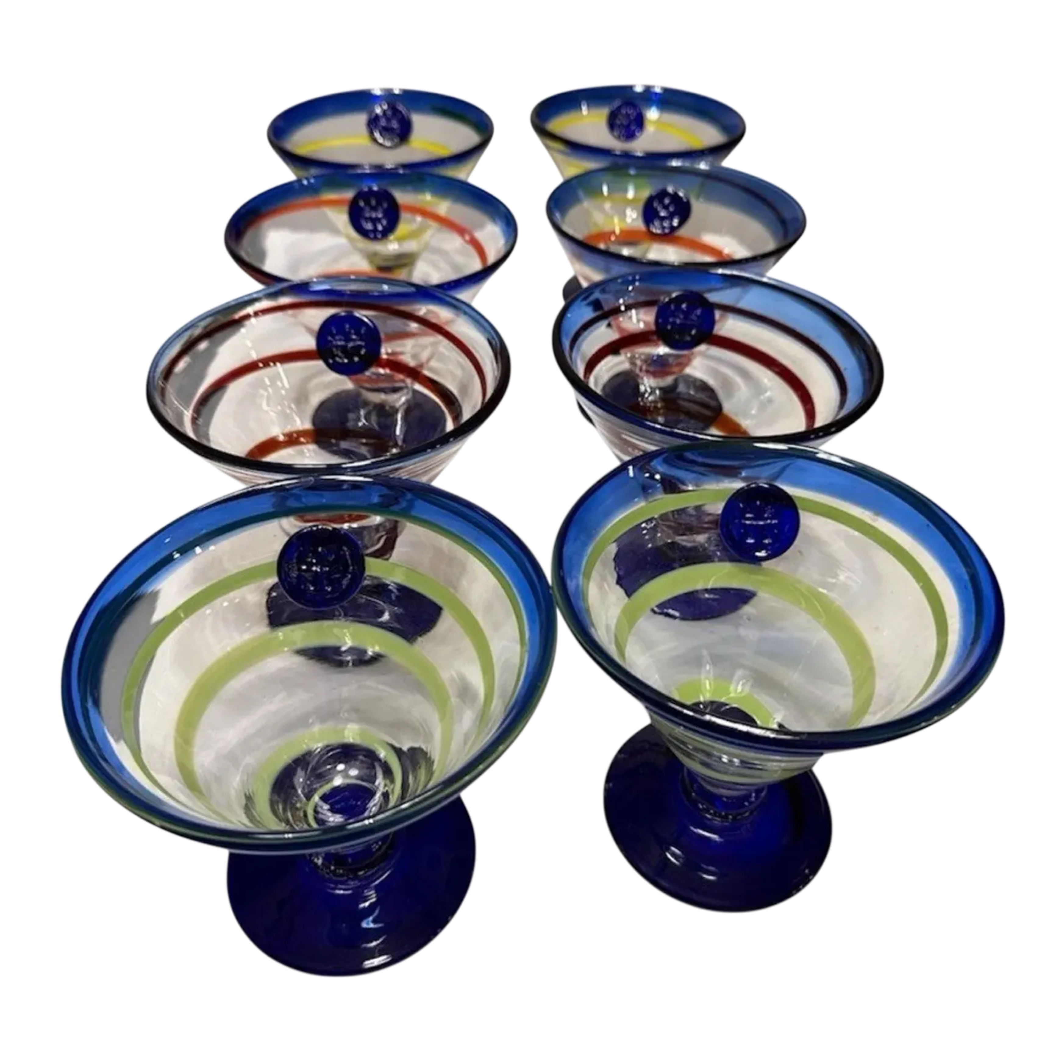 Rare full set of 8 Kosta Boda Royal Caribbean martini glasses. Hand-blown, cobalt base, mixed swirl colours. No longer made. The Home Edit by Boutique Kaotique.