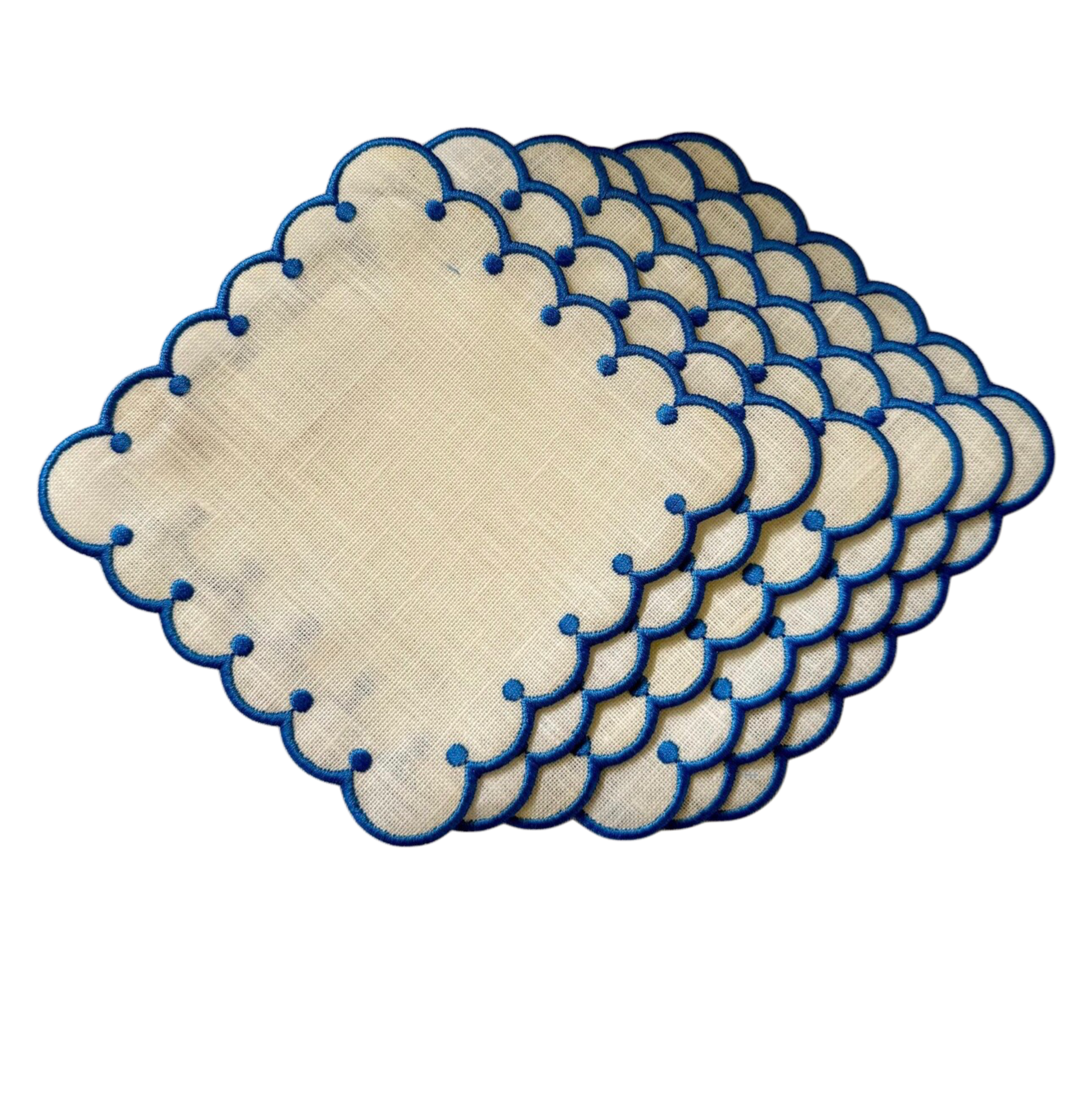 Set of beige placemats with blue scalloped edges on a white background