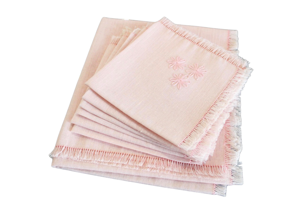 Set of pink napkins with fringe on a white background