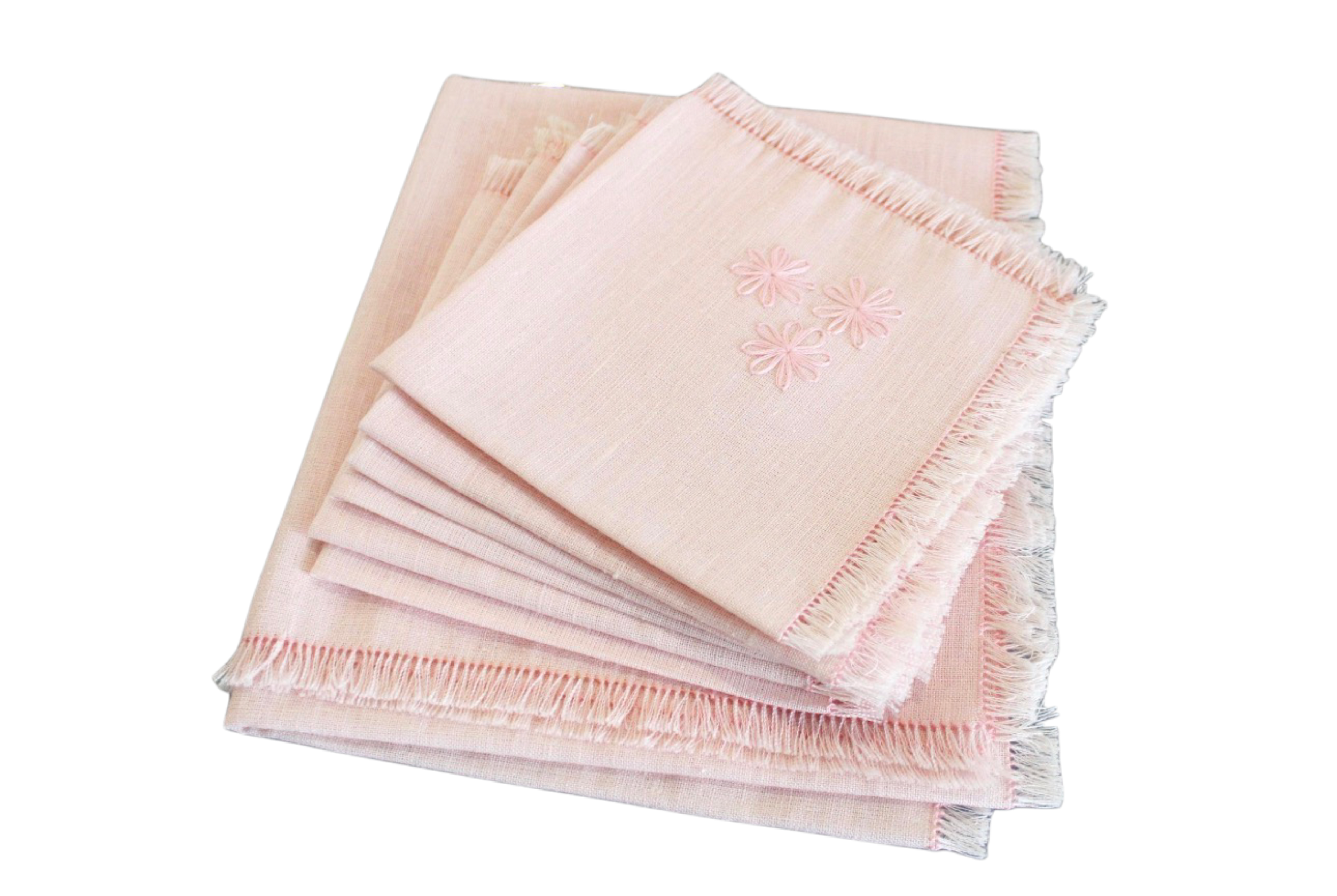 Set of pink napkins with fringe on a white background