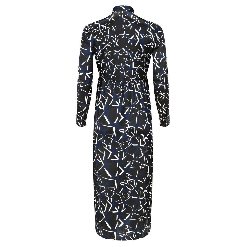 Long-sleeve dress with geometric pattern on a white background. Starry Night dress — handmade designer dress with starry print from Hanout Boutique Marrakech, fitted, limited edition occasion piece