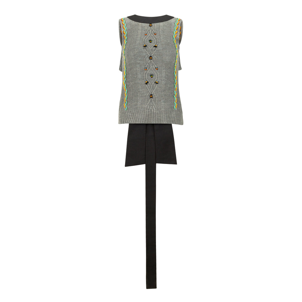 Sleeveless patterned top with black pants on a white background. Wool embroidered vest — handmade wool designer vest with hand-embroidery from Patrick Owen Jakarta, relaxed fit, limited edition