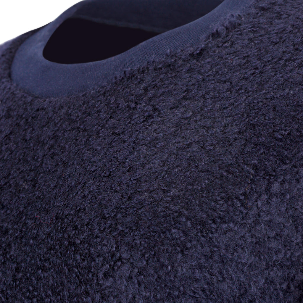 Close-up of a textured navy blue fabric. Navy wool cashmere jumper — handmade navy wool blend designer jumper from Hanout Boutique Marrakech, relaxed fit, limited edition