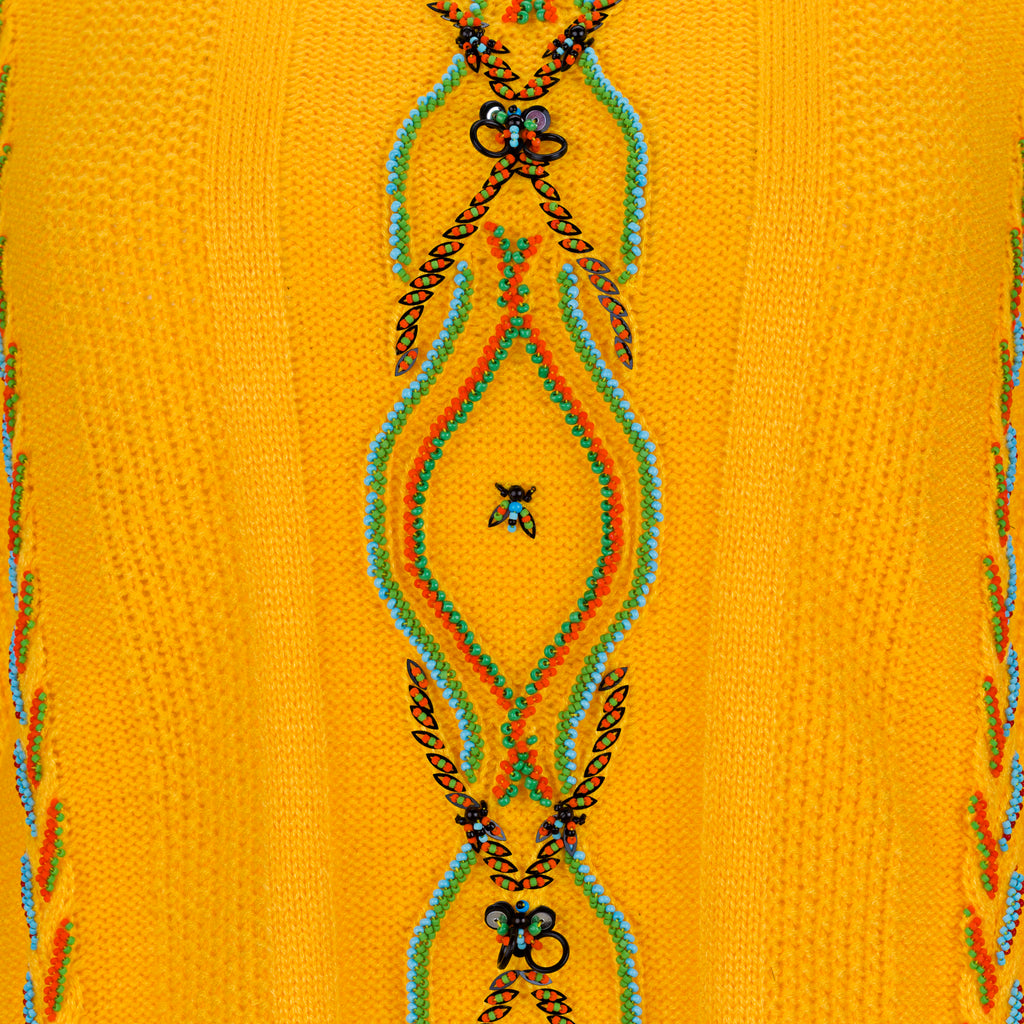 Decorative pattern on a yellow fabric with intricate designs. Yellow bug wool jumper — handmade yellow wool designer jumper with bug print from Patrick Owen Jakarta, relaxed fit, limited edition