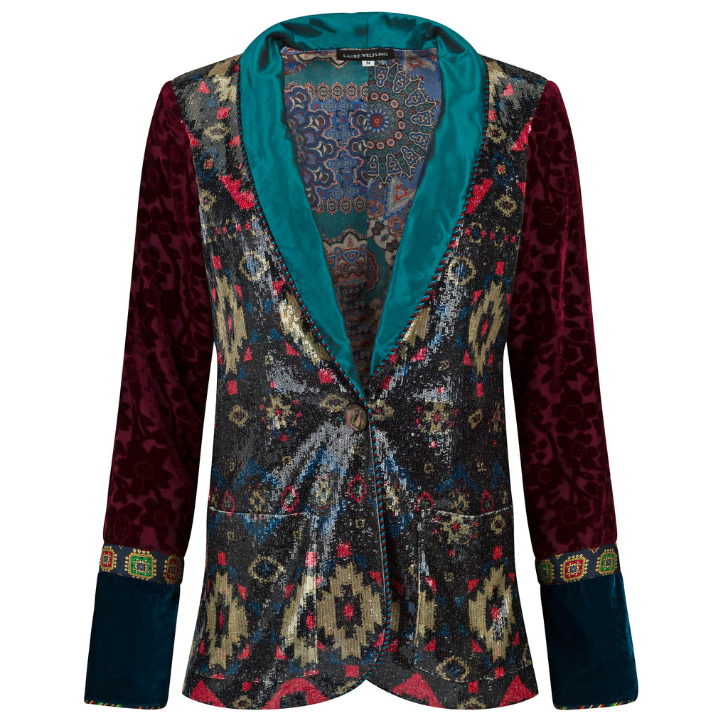 Colorful patterned jacket with a teal collar on a white background. Velvet sequins blazer — black velvet designer blazer with hand-stitched sequins from Laure Welfling Marrakech, limited edition