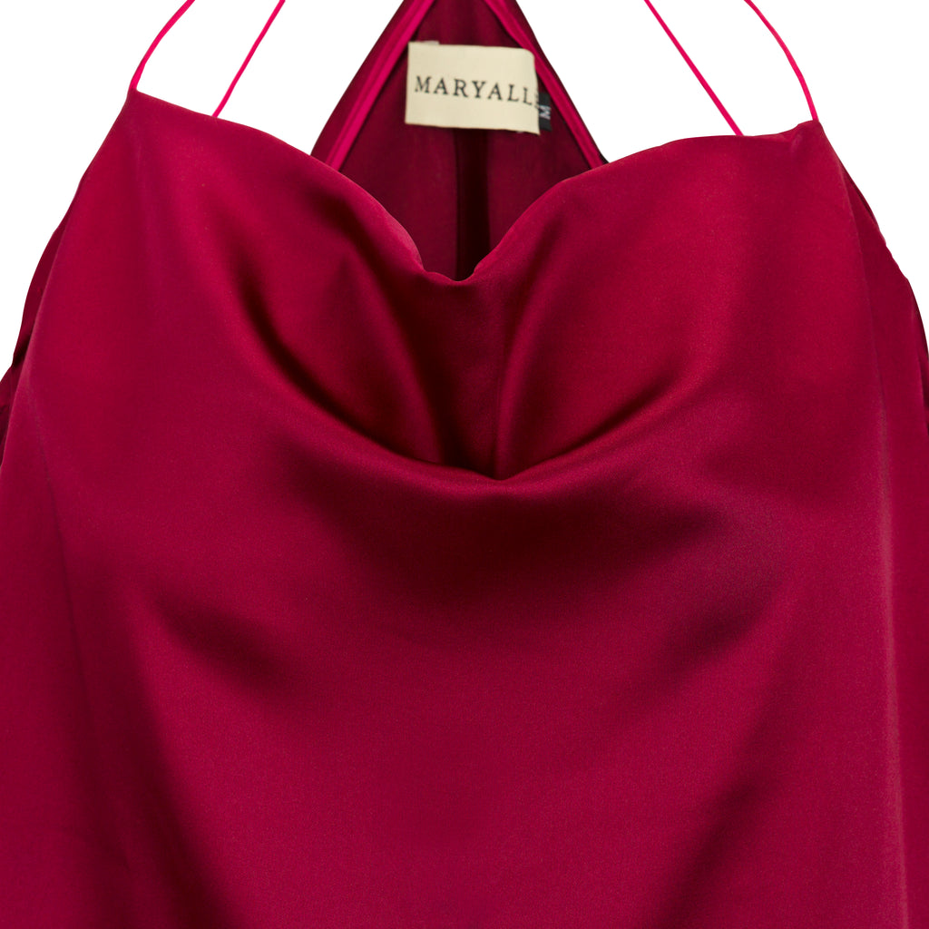 Close-up of a magenta dress with 'MARYALL' label on a white background. Cut out burgundy top — handmade burgundy designer top with cut-out detail from Maryallé Jakarta, fitted, limited edition