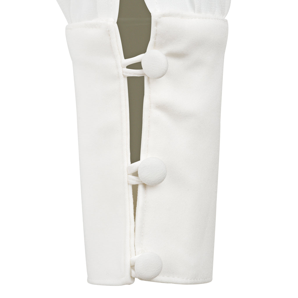 White leg warmers with buttons on a white background. Indonesian asymmetrical shirt — handmade asymmetric designer shirt from Maryallé Jakarta, fitted, limited edition piece