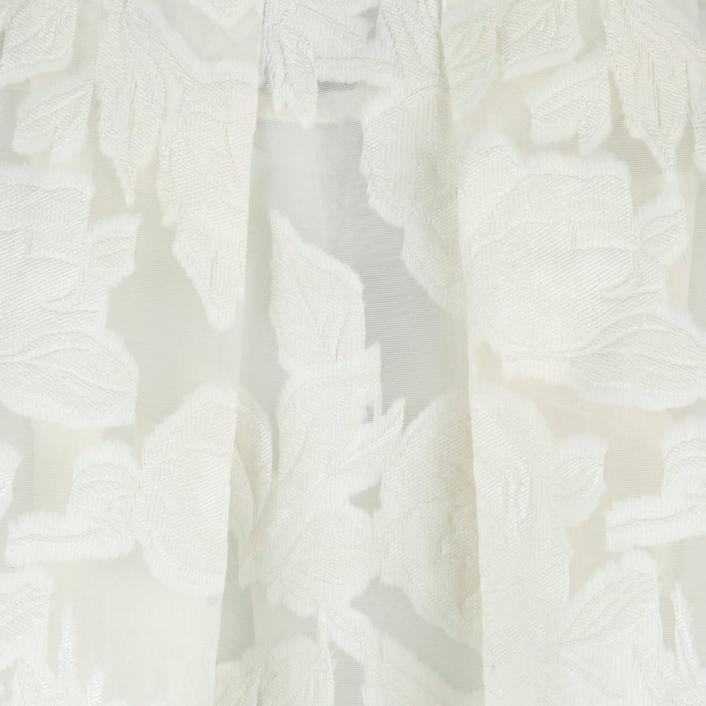 Close-up of white textured fabric. Indonesian lace dress top — handmade lace designer top from Maryallé Jakarta, fitted, limited edition occasion piece