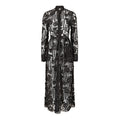 Black lace dress with floral patterns on a white background. Black lace dress — handmade black lace designer dress from Hanout Boutique Marrakech, fitted, limited edition occasion piece