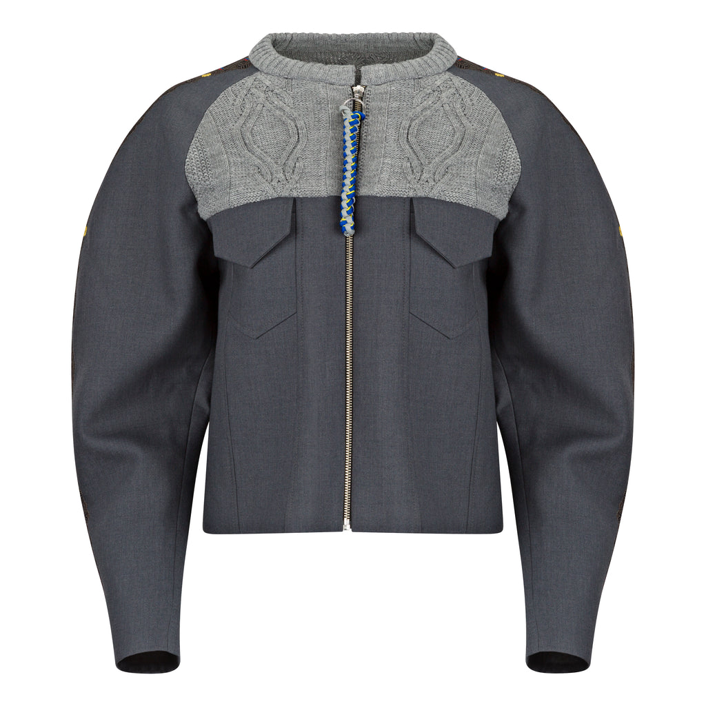 Gray jacket with a patterned gray and blue collar on a white background. Knitted bomber jacket — handmade designer knitted bomber from Patrick Owen Jakarta, relaxed fit, limited edition winter piece