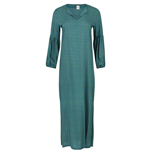 Long teal dress with a pattern on a white background. Moroccan blue floral summer cover up — handmade blue cotton kaftan with floral print from Owl Marrakech, limited edition