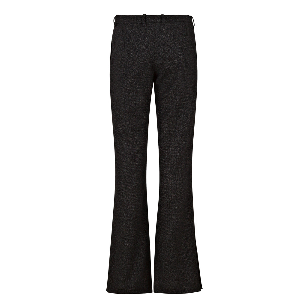 Black flared pants on a white background. Flared wool trousers — handmade designer flared wool trousers from Patrick Owen Jakarta, relaxed fit, limited edition winter piece