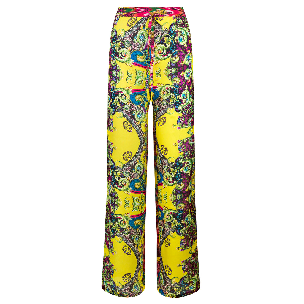 Colorful patterned pants on a white background. Yellow patterned silk pants — handmade yellow silk designer pants with groovy print from Hanout Boutique Marrakech, relaxed fit