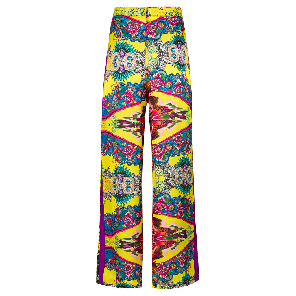 Colorful patterned pants on a white background. Yellow patterned silk pants — handmade yellow silk designer pants with groovy print from Hanout Boutique Marrakech, relaxed fit