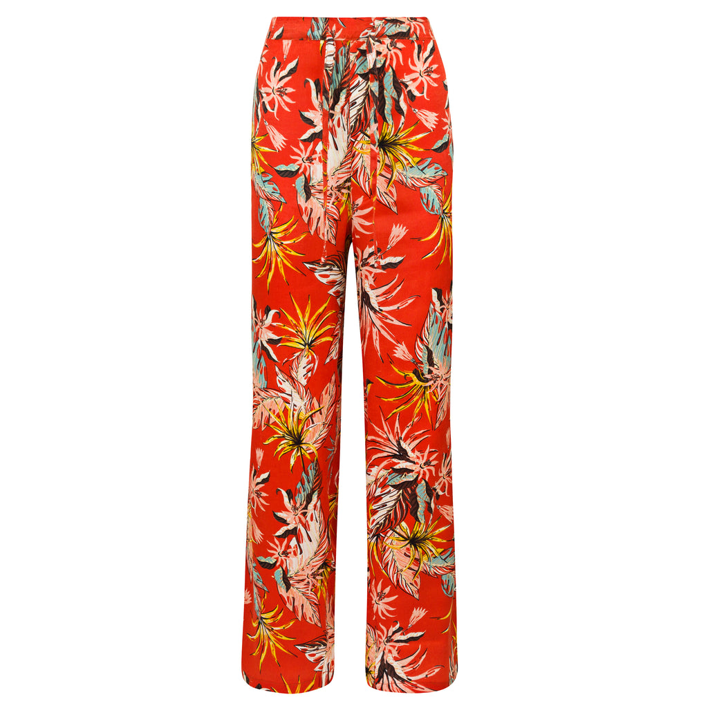 Red floral-patterned pants on a white background. Orange patterned silk pants — handmade orange silk designer pants with vibrant print from Hanout Boutique Marrakech, relaxed fit