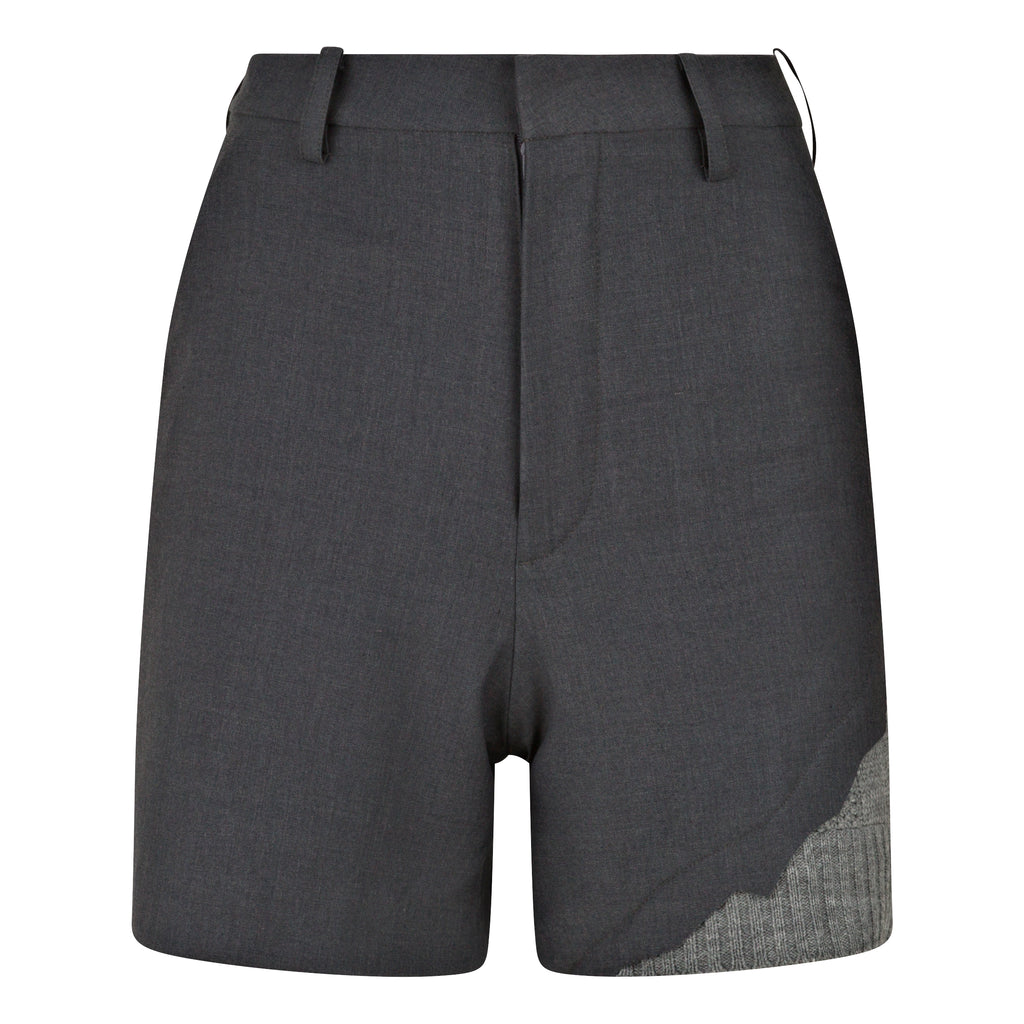 Gray shorts with a textured patch on a white background. Wool blend shorts — handmade designer wool blend shorts from Patrick Owen Jakarta, tailored fit, limited edition piece