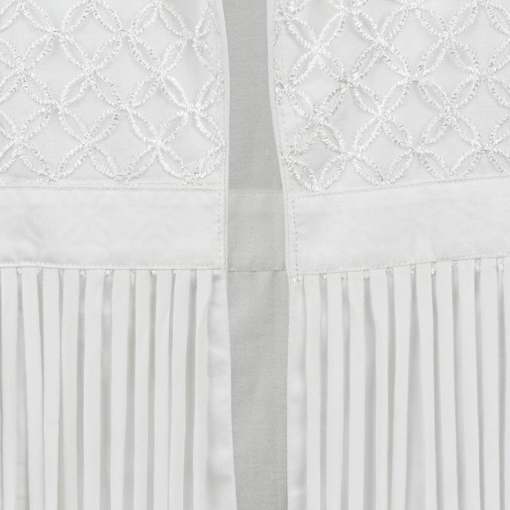 White fabric with embroidered lattice pattern and pleated hem. Indonesian stringy vest — handmade designer cotton vest with string detail from Major Minor Jakarta, relaxed fit, limited edition