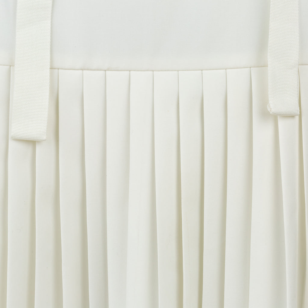 Close-up of a white pleated fabric texture. Indonesian asymmetrical skirt — handmade asymmetric designer skirt from Major Minor Jakarta, relaxed fit, limited edition