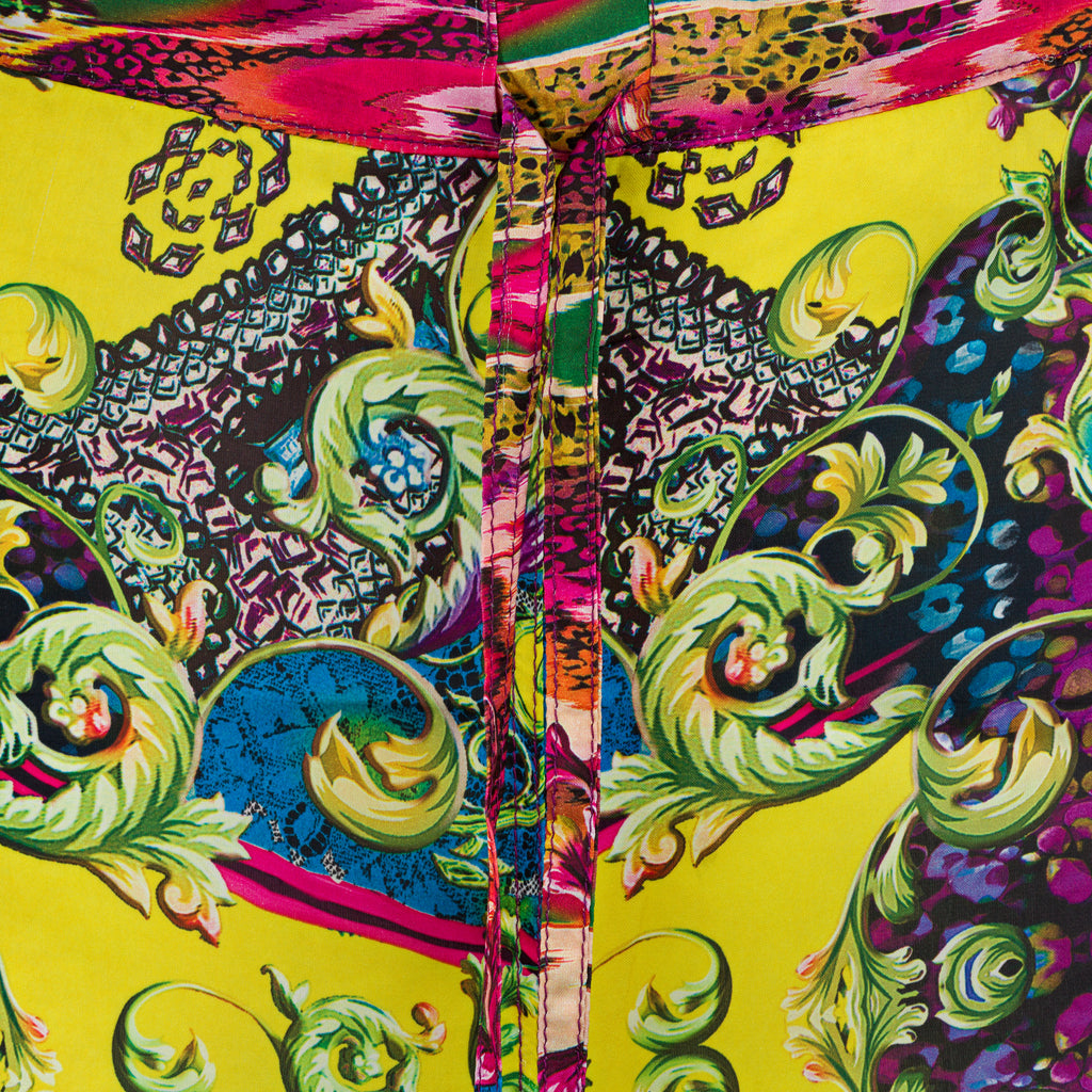 Colorful fabric with intricate patterns on a yellow background. Yellow patterned silk pants — handmade yellow silk designer pants with groovy print from Hanout Boutique Marrakech, relaxed fit