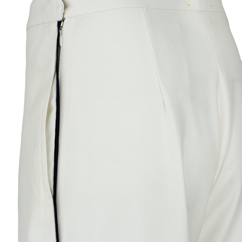Close-up of a white pants with a zipper on a white background. Extra loose trousers — handmade designer relaxed trousers from Major Minor Jakarta, oversized fit, limited edition summer