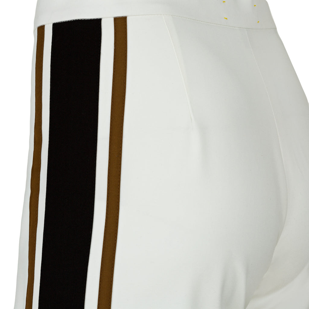 White pants with black and brown stripes on a white background. Striped trousers — handmade designer striped cotton trousers from Major Minor Jakarta, relaxed fit, limited edition summer