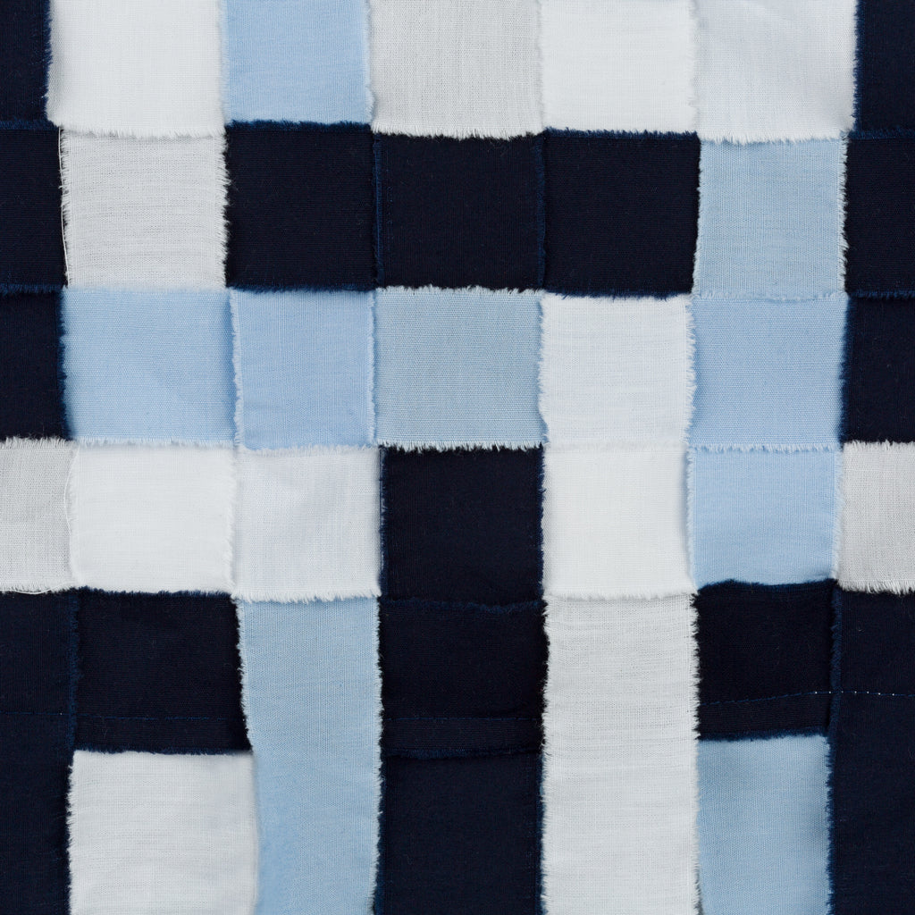 Close-up of a checkered fabric with blue, white, and navy squares. Indonesian stringy top — handmade designer cotton top with string detail from Major Minor Jakarta, relaxed fit, limited edition