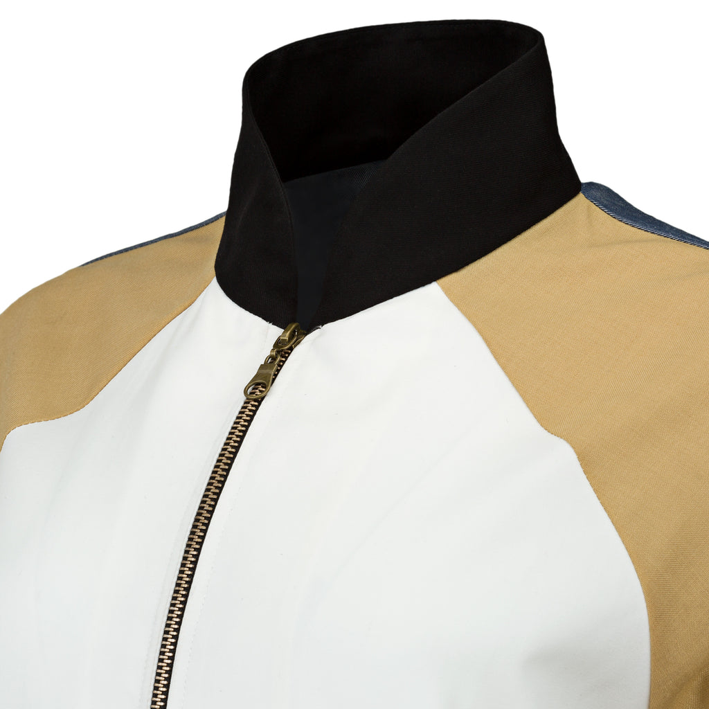 Close-up of a jacket with black collar, white front, and beige sleeves on a white background. Linen baseball jacket — handmade designer linen baseball jacket from Major Minor Jakarta, relaxed fit, limited edition summer