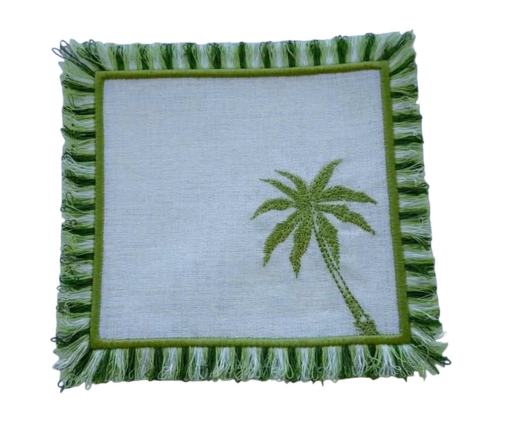 Square pillow with green palm tree design on a white background