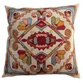 Decorative pillow with intricate geometric pattern on a beige background