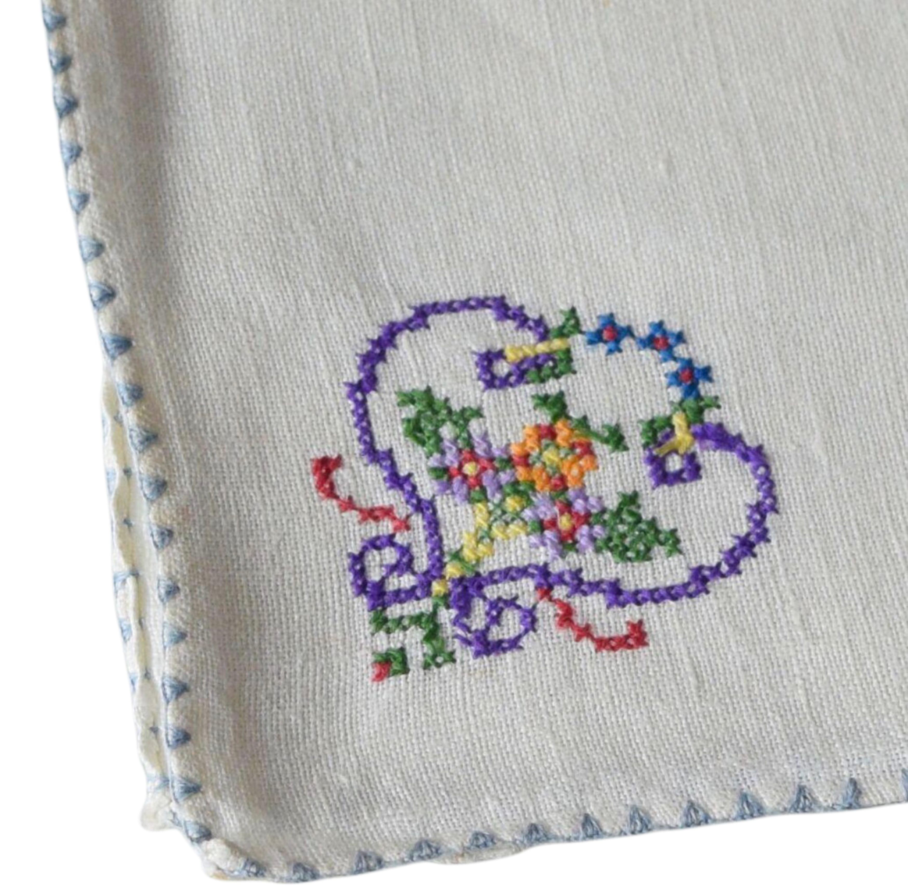 Embroidered design of a purple elephant with flowers on a white fabric background