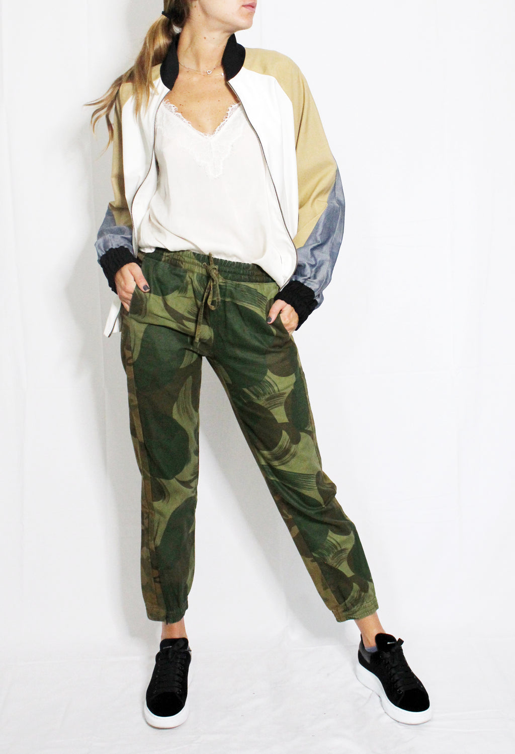 Person wearing a colorful jacket, white shirt, and camouflage pants on a white background. Linen baseball jacket — handmade designer linen baseball jacket from Major Minor Jakarta, relaxed fit, limited edition summer