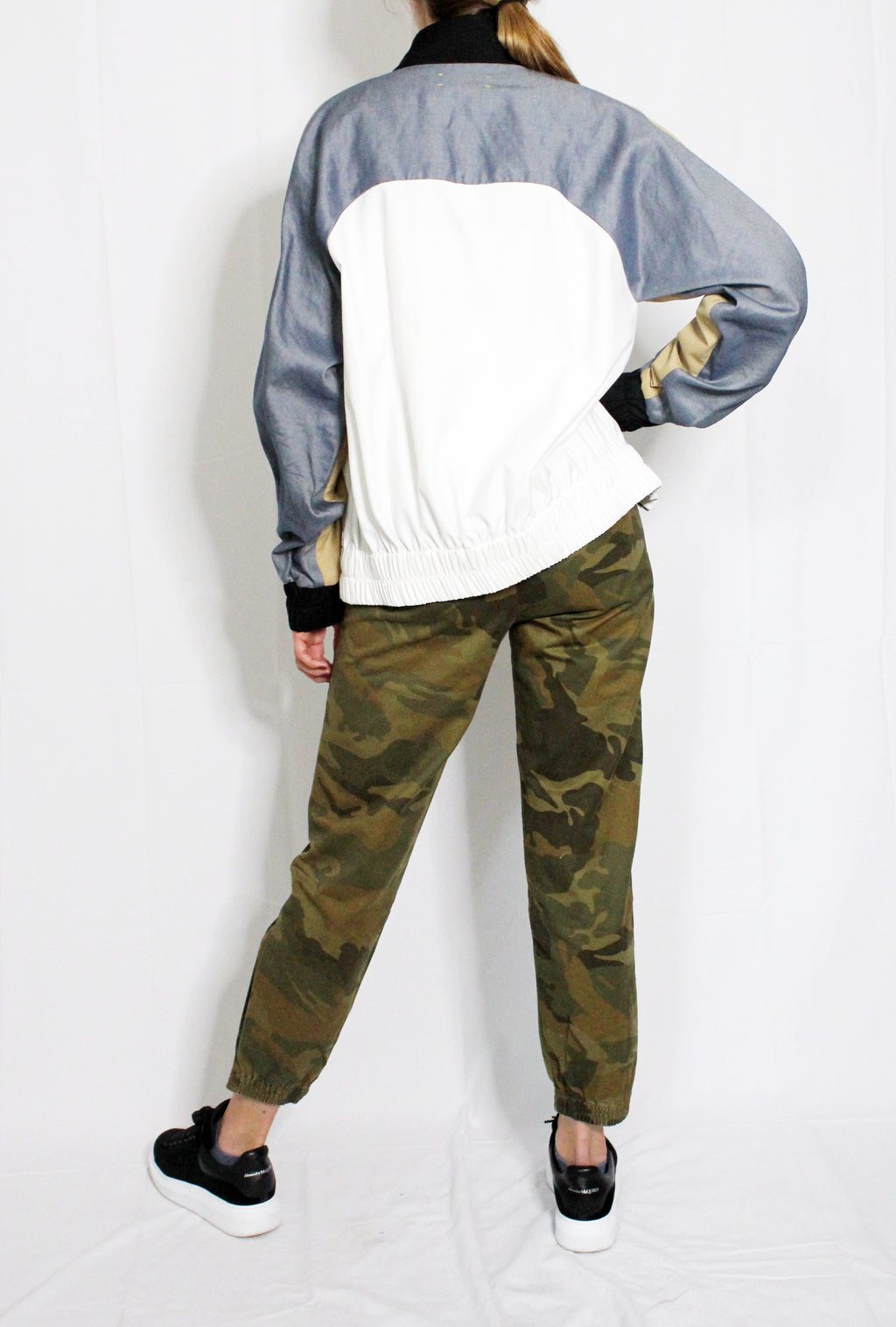 Person wearing a color-blocked jacket and camouflage pants on a white background. Linen baseball jacket — handmade designer linen baseball jacket from Major Minor Jakarta, relaxed fit, limited edition summer