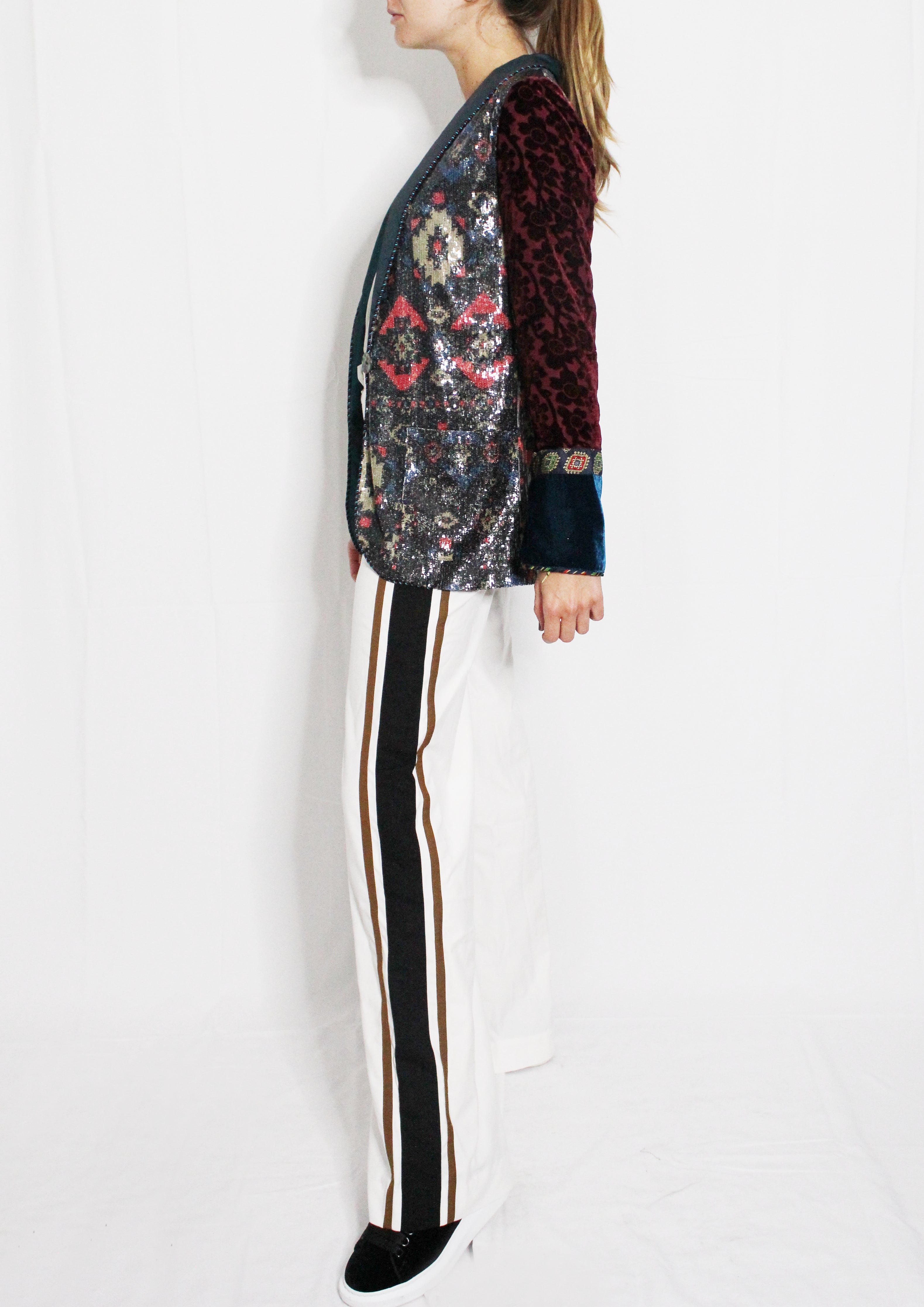 Person wearing a sequined jacket and striped pants on a white background. Striped trousers — handmade designer striped cotton trousers from Major Minor Jakarta, relaxed fit, limited edition summer