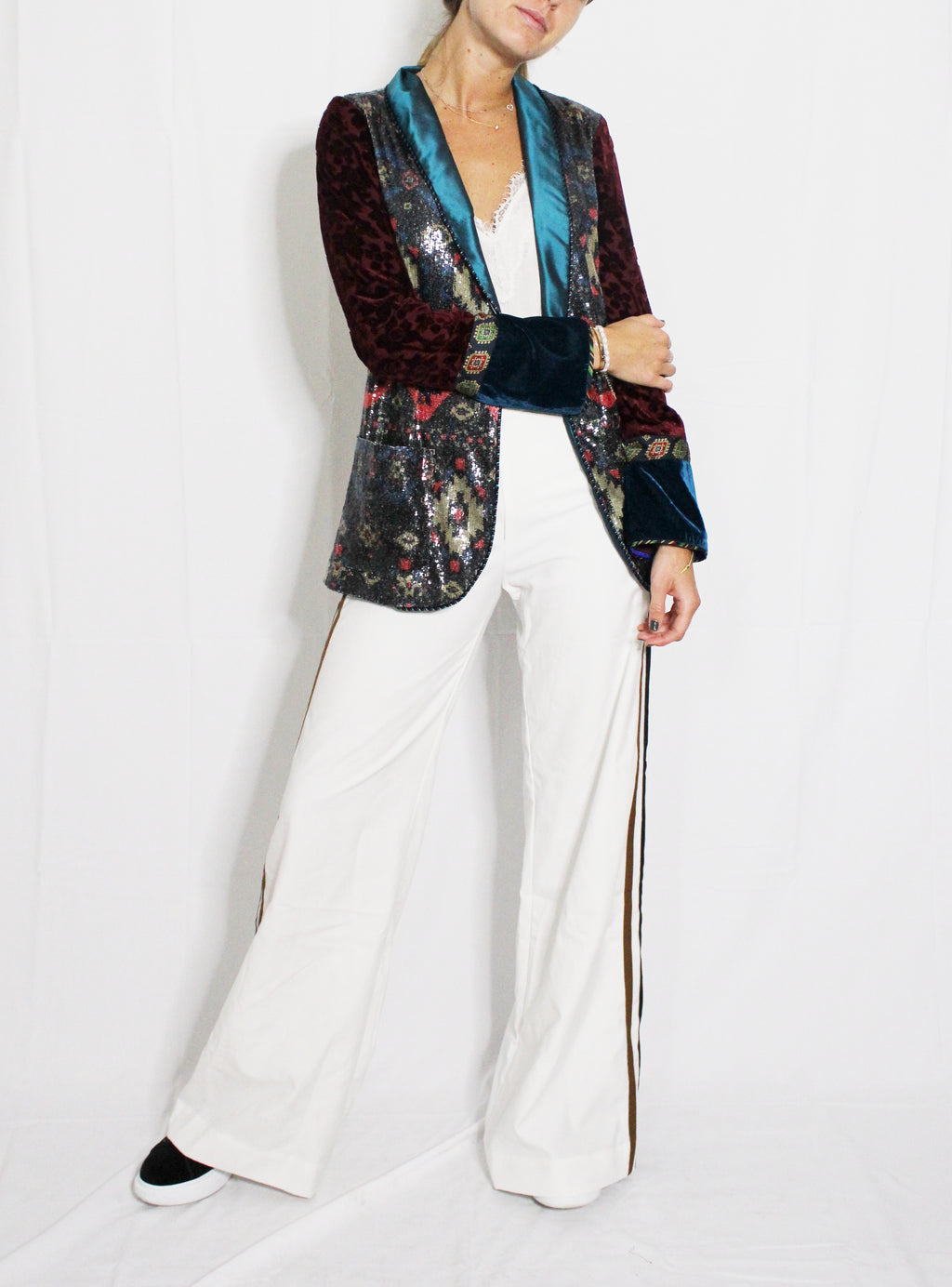 Person wearing a colorful blazer with floral patterns and white pants on a white background. Striped trousers — handmade designer striped cotton trousers from Major Minor Jakarta, relaxed fit, limited edition summer
