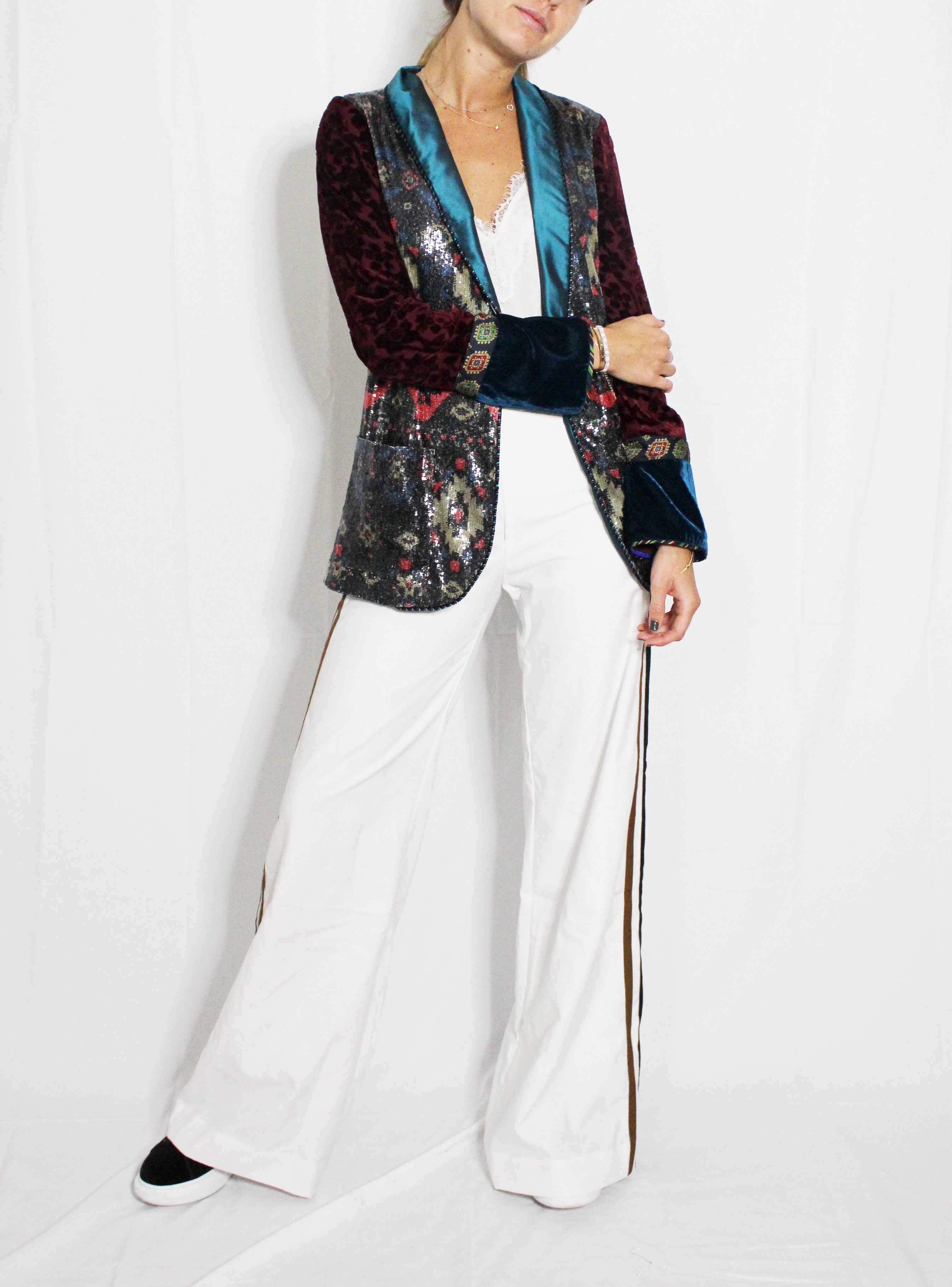Person wearing a colorful blazer with floral patterns and white pants on a white background. Striped trousers — handmade designer striped cotton trousers from Major Minor Jakarta, relaxed fit, limited edition summer