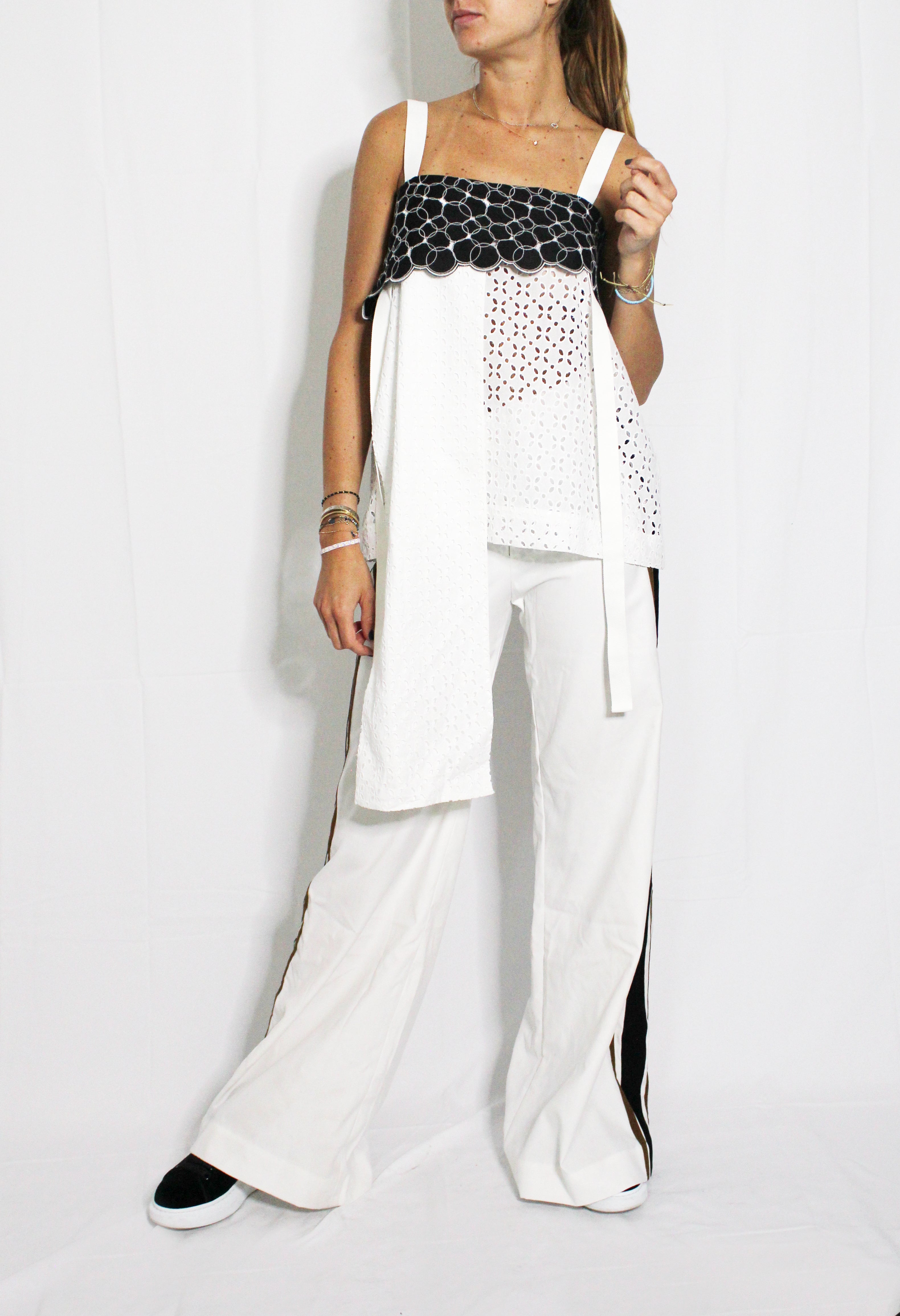 Woman wearing a black and white outfit with a white background. Striped trousers — handmade designer striped cotton trousers from Major Minor Jakarta, relaxed fit, limited edition summer