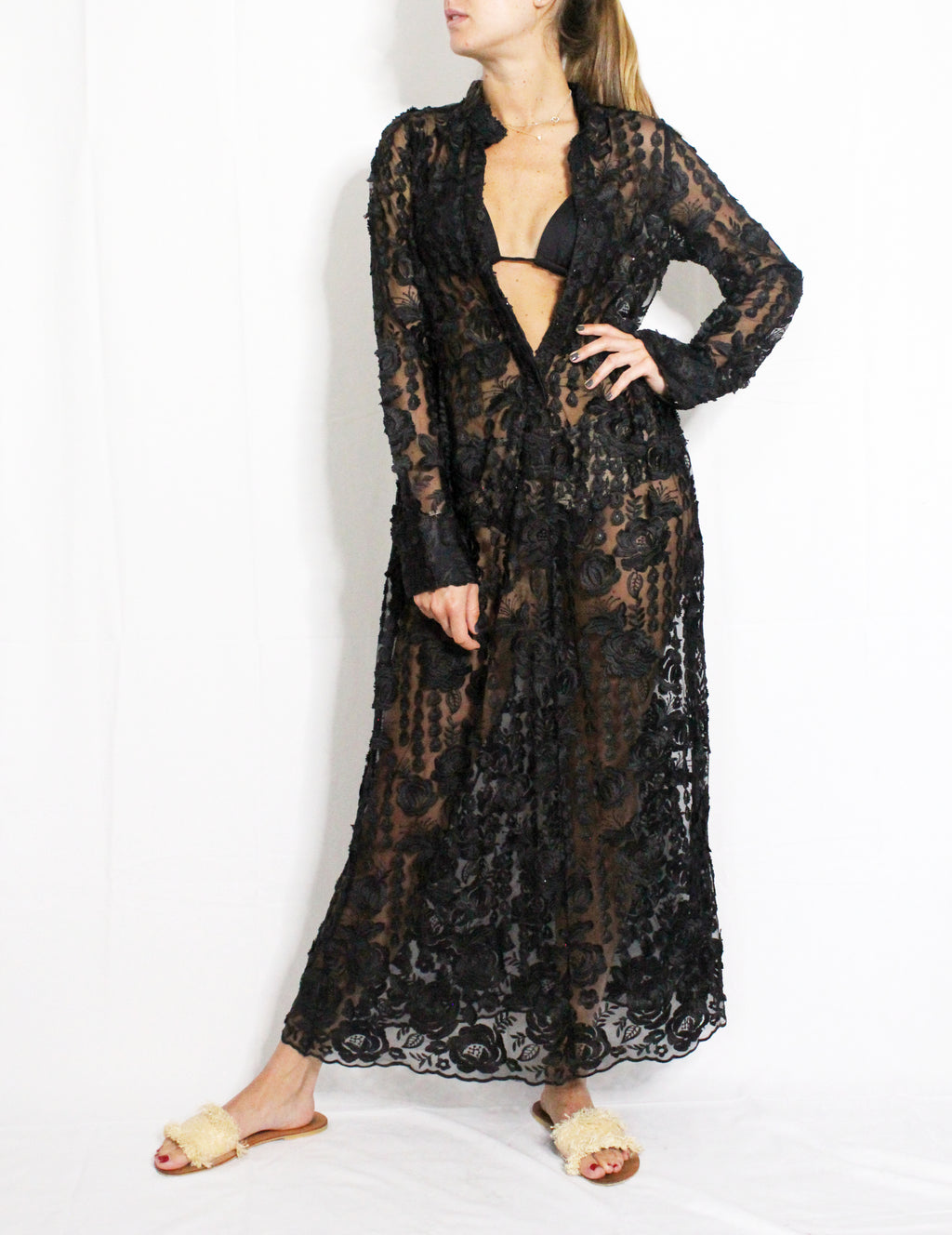 Black lace dress worn by a model on a white background. Black lace dress — handmade black lace designer dress from Hanout Boutique Marrakech, fitted, limited edition occasion piece