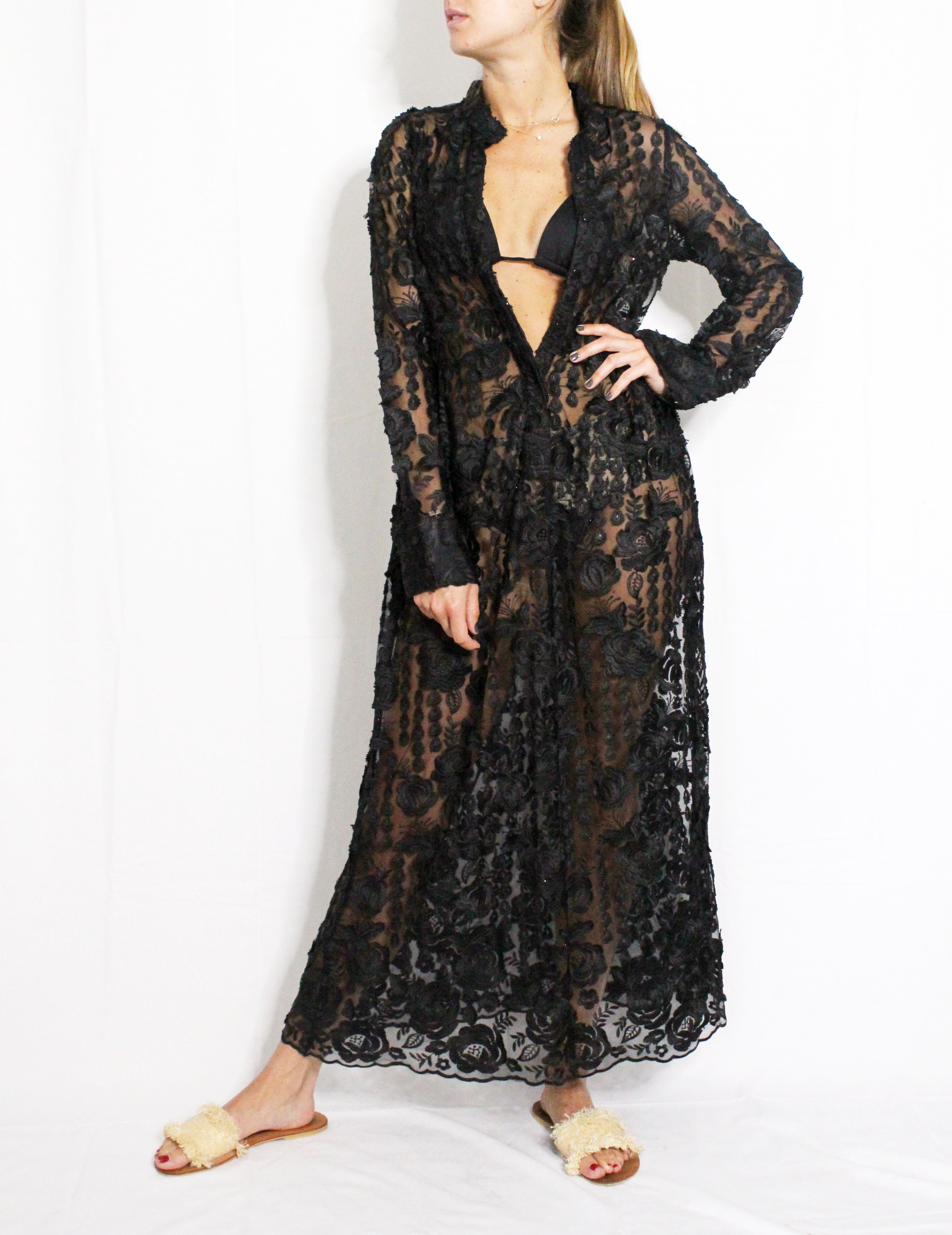 Black lace dress worn by a model on a white background. Black lace dress — handmade black lace designer dress from Hanout Boutique Marrakech, fitted, limited edition occasion piece