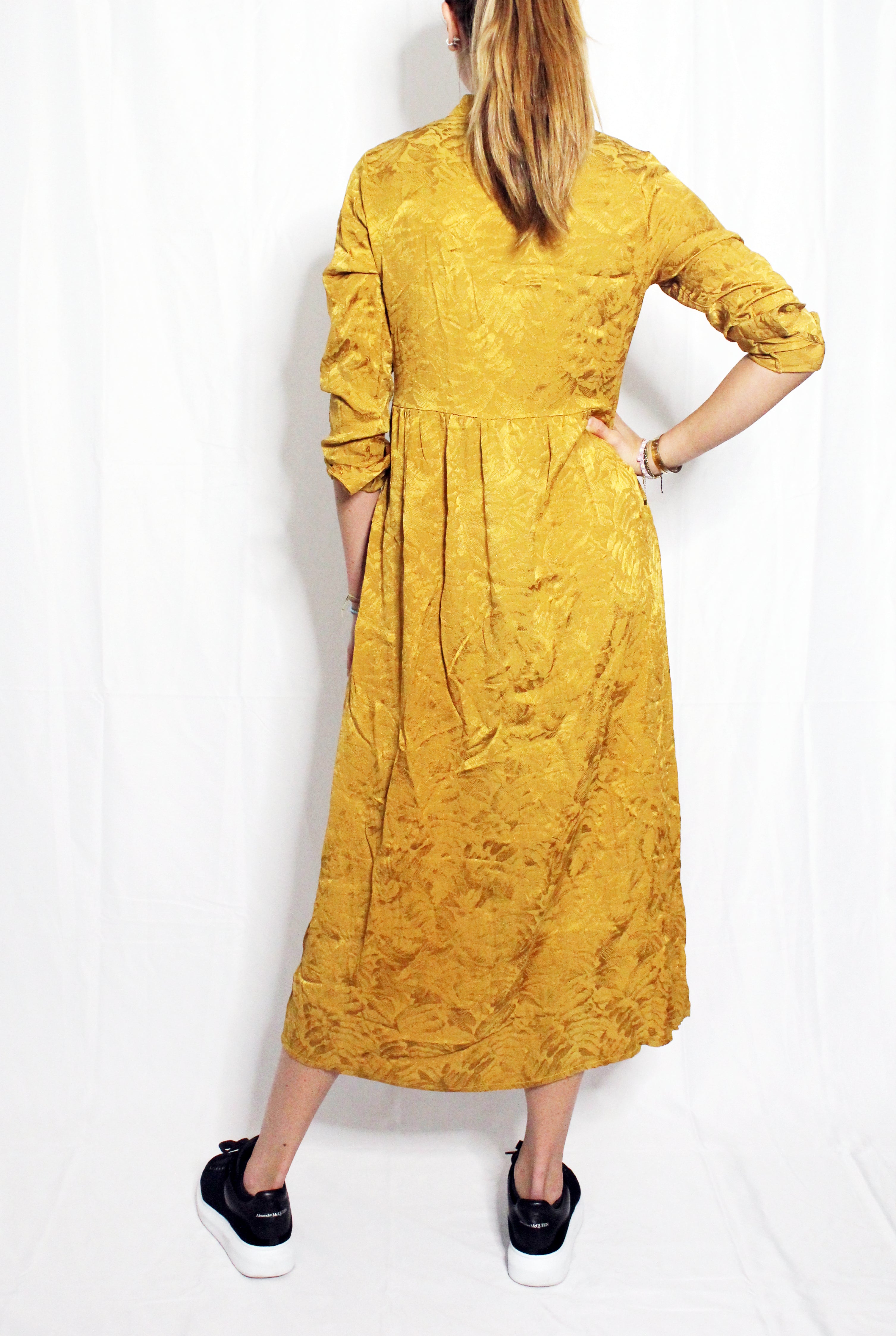 Person wearing a mustard yellow dress against a white background. Golden Hour dress — handmade yellow gold designer dress from Hanout Boutique Marrakech, fitted, limited edition occasion piece
