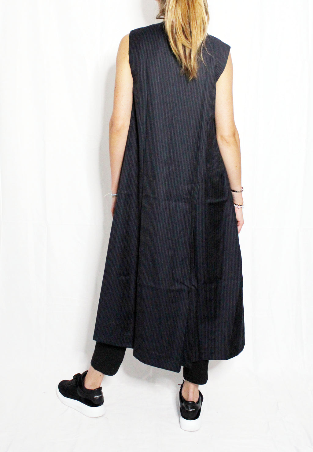 Person wearing a long black sleeveless vest against a white background. Soldier vest — handmade designer cotton vest from Major Minor Jakarta, relaxed fit, limited edition summer piece