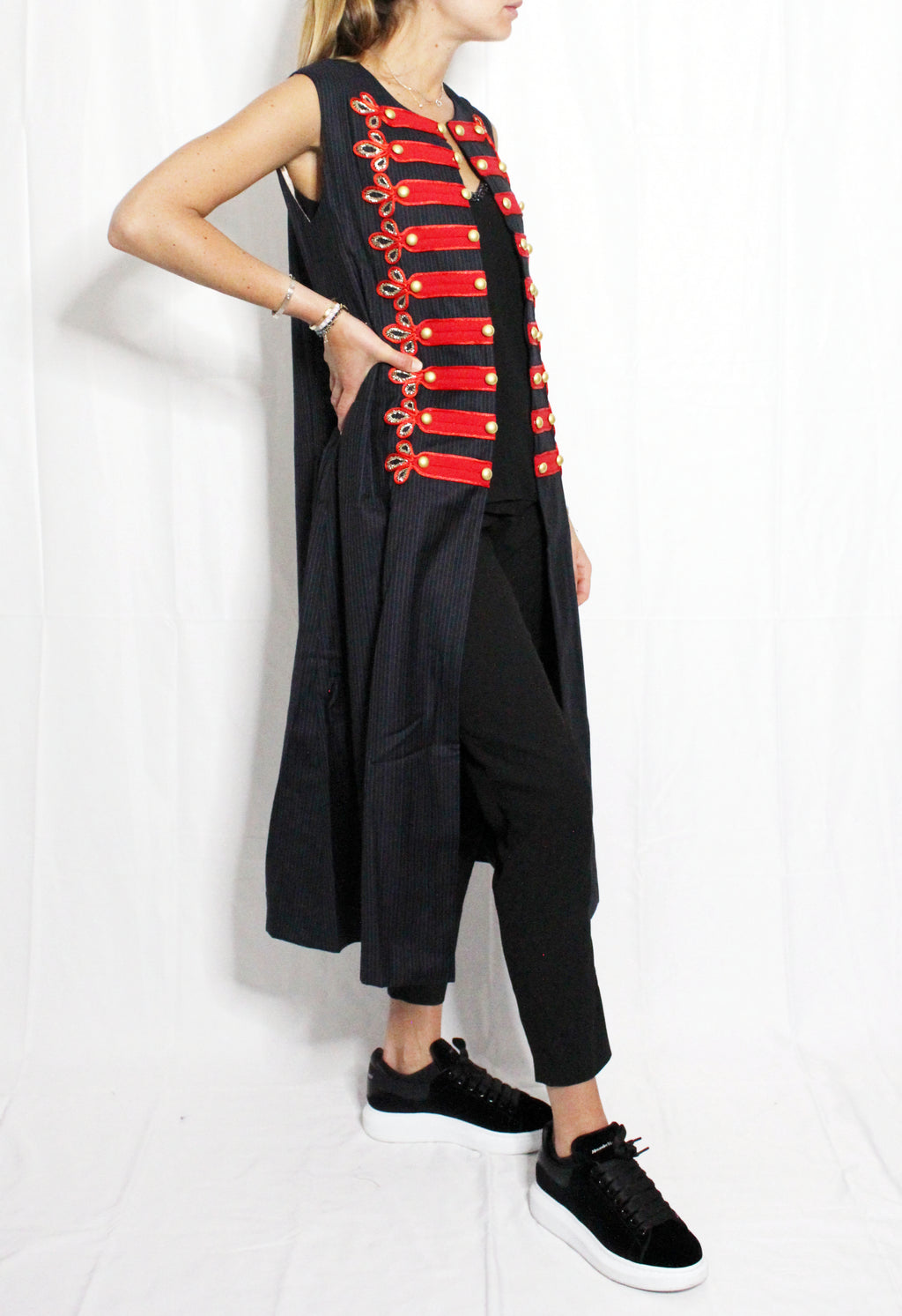 Person wearing a black outfit with red accents and black shoes on a white background. Soldier vest — handmade designer cotton vest from Major Minor Jakarta, relaxed fit, limited edition summer piece