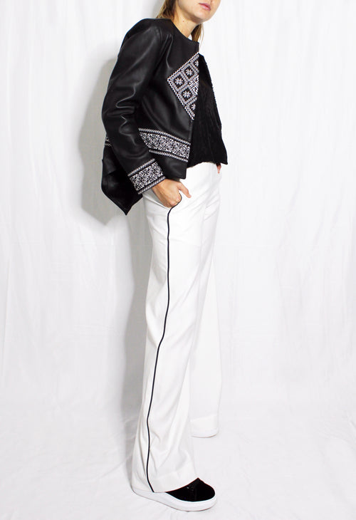 Person wearing a black and white outfit with geometric patterns on a white background. Extra loose trousers — handmade designer relaxed trousers from Major Minor Jakarta, oversized fit, limited edition summer
